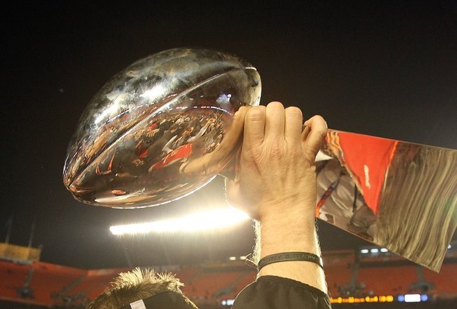 MIAMI GARDENS, FL - FEBRUARY 07:  Head coach Sean Payton of the New Orleans Saints leaves the field with the Vince Lombardi Trophy after his team defeated the Indianapolis Colts during Super Bowl XLIV on February 7, 2010 at Sun Life Stadium in Miami Gardens, Florida.  (Photo by Ronald Martinez/Getty Images)