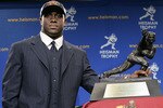 NEW YORK - DECEMBER 10:  Running back Reggie Bush #5 of the USC Trojans poses with the 2005 Heisman trophy after winning the award at the 71st Annual Heisman Ceremony on December 10, 2005 in New York City.  (Photo by Stephen Chernin/Getty Images)