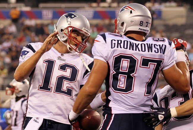 EAST RUTHERFORD, NJ - SEPTEMBER 02:  Tom Brady #12 and Rob Gronkowski #87 of the New England Patriots celebrate after teaming up for a first quarter touchdown against the New York Giants on September 2, 2010 at the New Meadowlands Stadium in East Rutherford, New Jersey.  (Photo by Jim McIsaac/Getty Images)
