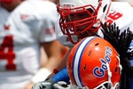 GAINESVILLE, FL - SEPTEMBER 04:  Linebacker Jonathan Bostic #52 of the Florida Gators is tackled by Thomas Merriweather #34 of the Miami University RedHawks following a interceptionat Ben Hill Griffin Stadium on September 4, 2010 in Gainesville, Florida.  (Photo by Sam Greenwood/Getty Images)