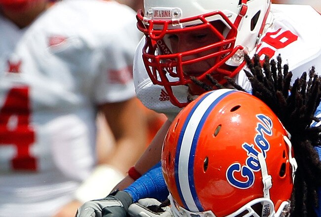 GAINESVILLE, FL - SEPTEMBER 04:  Linebacker Jonathan Bostic #52 of the Florida Gators is tackled by Thomas Merriweather #34 of the Miami University RedHawks following a interceptionat Ben Hill Griffin Stadium on September 4, 2010 in Gainesville, Florida.  (Photo by Sam Greenwood/Getty Images)