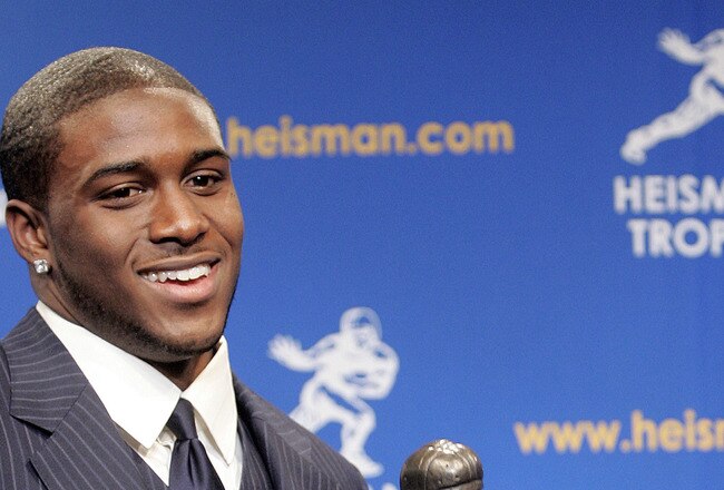 NEW YORK - DECEMBER 10:  Running back Reggie Bush #5 of the USC Trojans poses with the 2005 Heisman trophy after winning the award at the 71st Annual Heisman Ceremony on December 10, 2005 in New York City.  (Photo by Stephen Chernin/Getty Images)