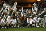 TEMPE, AZ - JANUARY 3:  Before seeing the flag thrown by an official, the Miami Hurricanes players and the coaches celebrate at the end of the first over-time against the Ohio State Buckeyes in the Tostitos Fiesta Bowl on January 3, 2003 at Sun Devil Stadium in Tempe, Arizona.  Ohio State won the game 31-24 in double-overtime, winning the NCAA National Championship. (Photo by Elsa/Getty Images)