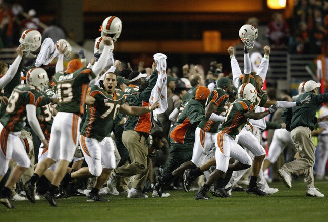 TEMPE, AZ - JANUARY 3:  Before seeing the flag thrown by an official, the Miami Hurricanes players and the coaches celebrate at the end of the first over-time against the Ohio State Buckeyes in the Tostitos Fiesta Bowl on January 3, 2003 at Sun Devil Stadium in Tempe, Arizona.  Ohio State won the game 31-24 in double-overtime, winning the NCAA National Championship. (Photo by Elsa/Getty Images)