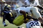 ANN ARBOR, MI - SEPTEMBER 12:  Denard Robinson #16 of Michigan gets tackled by Robert Blanton #12 of Notre Dame at Michigan Stadium on September 12, 2009 in Ann Arbor, Michigan.  (Photo by Domenic Centofanti/Getty Images)