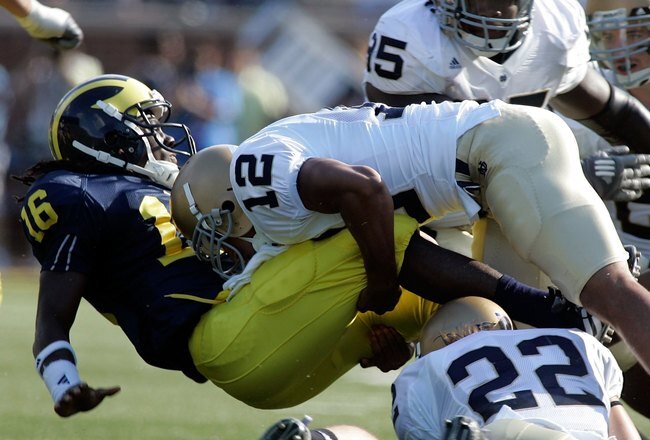 ANN ARBOR, MI - SEPTEMBER 12:  Denard Robinson #16 of Michigan gets tackled by Robert Blanton #12 of Notre Dame at Michigan Stadium on September 12, 2009 in Ann Arbor, Michigan.  (Photo by Domenic Centofanti/Getty Images)