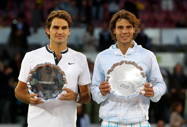 MADRID, SPAIN - MAY 16:  Mens finalist Rafael Nadal and  Roger Federer of Switzerland hold aloft their trophies after the mens final match during the Mutua Madrilena Madrid Open tennis tournament at the Caja Magica on May 16, 2010 in Madrid, Spain.  (Photo by Clive Brunskill/Getty Images)