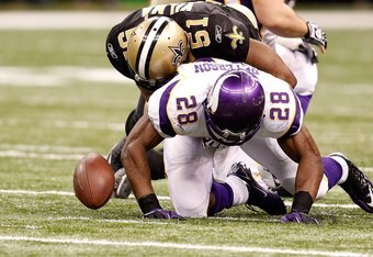 NEW ORLEANS - JANUARY 24: Adrian Peterson #28 of the Minnesota Vikings fumbles the ball as he was hit by Jonathan Vilma #51 of the New Orleans Saints during the NFC Championship Game at the Louisiana Superdome on January 24, 2010 in New Orleans, Louisiana. (Photo by Chris Graythen/Getty Images)