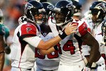 MIAMI - AUGUST 27:  Quarterback Matt Ryan #2  (L) and wide reciever Roddy White #84 (C) of the Atlanta Falcons celebrate a touchdown catch by White against the Miami Dolphins during their preseason game at Sun Life Stadium on August 27, 2010 in Miami, Florida.  (Photo by Marc Serota/Getty Images)