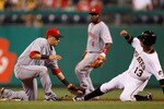 PITTSBURGH - AUGUST 03:  Paul Janish #7 of the Cincinnati Reds tags out Ronny Cedeno #13 of the Pittsburgh Pirates during the game on August 3, 2010 at PNC Park in Pittsburgh, Pennsylvania.  (Photo by Jared Wickerham/Getty Images)