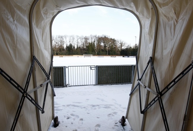 LONDON, ENGLAND - JANUARY 9 : The view through the player's tunnel at the snowy conditions at Hampton and Richmond borough FC's ground causing home games at The Beveree Stadium to be cancelled on January 9, 2010 in London, England. Extremely cold conditions are continuing to grip the UK with many overnight temperatures falling to -10 degrees Celsius and the Scottish village of Sutherland recording -22C.  (Photo by Jed Leicester/Getty Images)