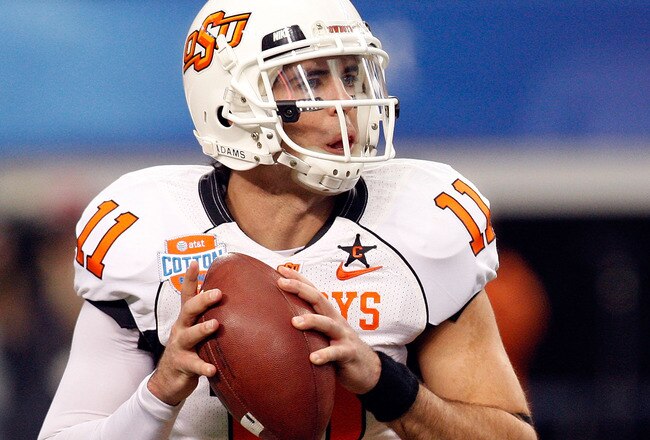 ARLINGTON, TX - JANUARY 02:  Quarterback Zac Robinson #11 of the Oklahoma State Cowboys drops back to pass against the Mississippi Rebels during the AT&T Cotton Bowl on January 2, 2010 at Cowboys Stadium in Arlington, Texas.  (Photo by Ronald Martinez/Getty Images)