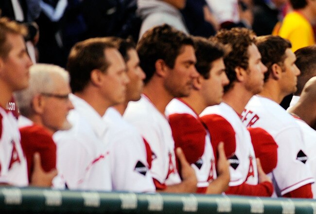 ANAHEIM, CA - APRIL 10:  Los Angeles Angels players bow their heads during national anthem before a moment of silence for rookie pitcher Nick Adenhart  before the start of the game against Boston red Sox at Angel Stadium April 10, 2009 in Anaheim, California. Adenhart and two others were killed in car crash on April 9.  (Photo by Kevork Djansezian/Getty Images)