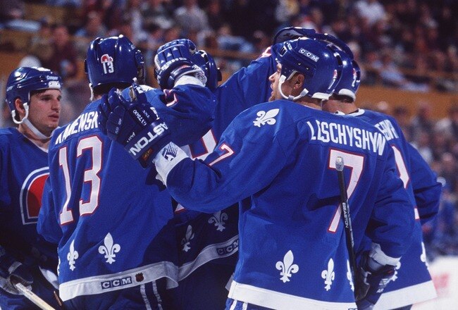 28 MAR 1995:  QUEBEC PLAYERS CELEBRATE FOLLOWING A GOAL DURING THE NORDIQUES GAME VERSUS THE BUFFALO SABRES AT THE AUD IN BUFFALO, NEW YORK. Mandatory Credit: Rick Stewart/ALLSPORT