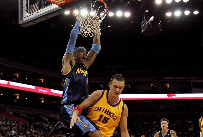 OAKLAND, CA - JANUARY 20:  Kenyon Martin #4 of the Denver Nuggets dunks on Andris Biedrins #15 of the Golden State Warriors at Oracle Arena on January 20, 2010 in Oakland, California.  NOTE TO USER: User expressly acknowledges and agrees that, by downloading and/or using this Photograph, user is consenting to the terms and conditions of the Getty Images License Agreement.  (Photo by Ezra Shaw/Getty Images)