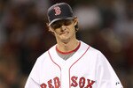 BOSTON - SEPTEMBER 29:  Clay Buchholz #61 of the Boston Red Sox reacts after the first inning against the Toronto Blue Jays on September 29, 2009 at Fenway Park in Boston, Massachusetts.  (Photo by Elsa/Getty Images)