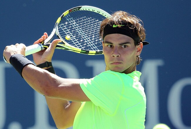 NEW YORK - SEPTEMBER 11:  Rafael Nadal of Spain returns a shot while playing against Mikhail Youzhny of Russia during his men's singles semifinal match on day thirteen of the 2010 U.S. Open at the USTA Billie Jean King National Tennis Center on September 11, 2010 in the Flushing neighborhood of the Queens borough of New York City.  (Photo by Nick Laham/Getty Images)