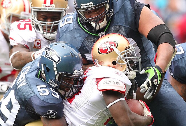 SEATTLE - SEPTEMBER 12:  Running back Frank Gore #21 of the San Francisco 49ers is wrapped up by Red Bryant #79 and Aaron Curry #59 during the NFL season opener against the Seattle Seahawks at Qwest Field on September 12, 2010 in Seattle, Washington. (Photo by Otto Greule Jr/Getty Images)