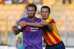 LECCE, ITALY - SEPTEMBER 12: Gustavo Castillo (R) of US Lecce battles for the ball with Alberto Gilardino of ACF Fiorentina during the Serie A match between Lecce and Fiorentina at Stadio Via del Mare on September 12, 2010 in Lecce, Italy.  (Photo by Maurizio Lagana/Getty Images)