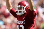 NORMAN, OK - SEPTEMBER 11:  Quarterback Landry Jones #12 of the Oklahoma Sooners celebrates a touchdown against the Florida State Seminoles in the first quarter at Gaylord Family Oklahoma Memorial Stadium on September 11, 2010 in Norman, Oklahoma.  (Photo by Ronald Martinez/Getty Images)