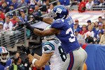 EAST RUTHERFORD, NJ - SEPTEMBER 12:  Deon Grant #34 of the New York Giants intercepts a pass in the endzone intended for Gary Barnidge #82 of the Carolina Panthers as teammate Kenny Phillips #21 defends during the first quarter on September 12, 2010 at the New Meadowlands Stadium in East Rutherford, New Jersey.  (Photo by Jim McIsaac/Getty Images)