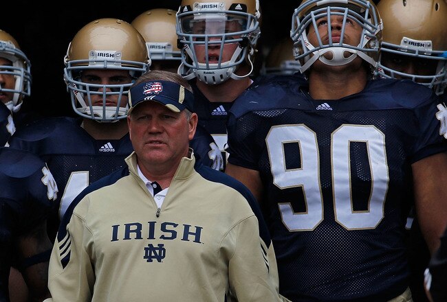 SOUTH BEND, IN - SEPTEMBER 11: Head coach Brian Kelly of the Notre Dame Fighting Irish waits to enter the field with his team including Carlo Calabrese #44 and Ethan Johnson #90 before a game against the Michigan Wolverines at Notre Dame Stadium on September 11, 2010 in South Bend, Indiana. Michigan defeated Notre Dame 28-24. (Photo by Jonathan Daniel/Getty Images)