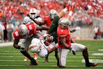 COLUMBUS, OH - SEPTEMBER 11:  Chase Ford #9 of the Miami Hurricanes is upended by Solomon Thomas #98 of the Ohio State Buckeyes and Jermale Hines #7 of the Ohio State Buckeyes at Ohio Stadium on September 11, 2010 in Columbus, Ohio.  (Photo by Jamie Sabau/Getty Images)