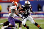 ATLANTA - DECEMBER 31:  Ben Tate #44 of the Auburn University Tigers runs against Chris Chancellor #38 of the Clemson University Tigers during the Chick-Fil-A Bowl on December 31, 2007 at the Georgia Dome in Atlanta, Georgia.  (Photo by Chris Graythen/Getty Images)