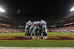 LANDOVER - SEPTEMBER 12:  The Dallas Cowboys offense huddles during the NFL season opener against the Washington Redskins at FedExField on September 12, 2010 in Landover, Maryland. The Redskins defeated the Cowboys 13-7. (Photo by Larry French/Getty Images)