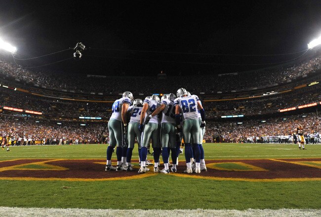 LANDOVER - SEPTEMBER 12:  The Dallas Cowboys offense huddles during the NFL season opener against the Washington Redskins at FedExField on September 12, 2010 in Landover, Maryland. The Redskins defeated the Cowboys 13-7. (Photo by Larry French/Getty Images)