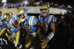PASADENA, CA - SEPTEMBER 11:  Richard Brehaut #12, Sheldon Price #22 and Dalton Hilliard #19 of UCLA rush out to the field before the game against Stanford at the Rose Bowl on September 11, 2010 in Pasadena, California.  (Photo by Harry How/Getty Images)