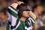 EAST RUTHERFORD, NJ - SEPTEMBER 13:  A fan of the New York Jets reacts after a play against the Baltimore Ravens during their home opener at the New Meadowlands Stadium on September 13, 2010 in East Rutherford, New Jersey.  (Photo by Jim McIsaac/Getty Images)