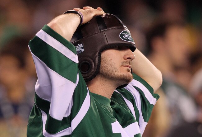 EAST RUTHERFORD, NJ - SEPTEMBER 13:  A fan of the New York Jets reacts after a play against the Baltimore Ravens during their home opener at the New Meadowlands Stadium on September 13, 2010 in East Rutherford, New Jersey.  (Photo by Jim McIsaac/Getty Images)