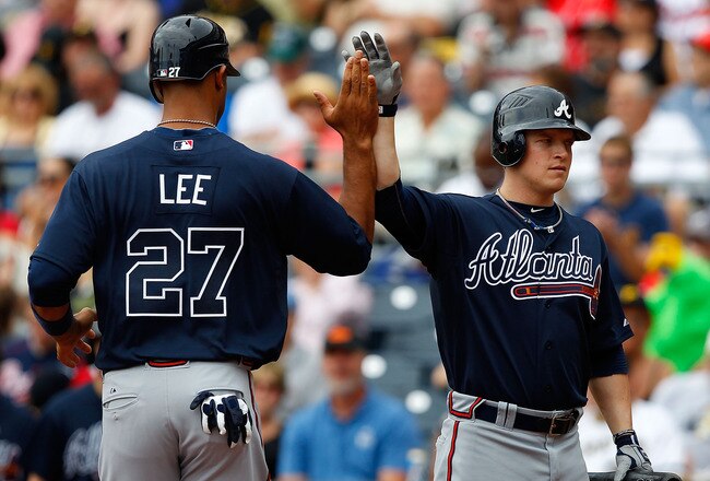 PITTSBURGH - SEPTEMBER 06:  Derrek Lee #27 of the Atlanta Braves is congratulated by teammate Nate McLouth #24 after scoring in the second inning against the Pittsburgh Pirates during the game on September 6, 2010 at PNC Park in Pittsburgh, Pennsylvania.  (Photo by Jared Wickerham/Getty Images)