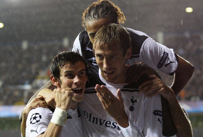 LONDON, ENGLAND - AUGUST 25:  Peter Crouch of Tottenham Hotspur celebrates with team mates Benoit Assou-Ekotto and Gareth Bale as he scores their third goal during the UEFA Champions League play-off second leg match between Tottenham Hotspur and BSC Young Boys at White Hart Lane on August 25, 2010 in London, England.  (Photo by Clive Rose/Getty Images)
