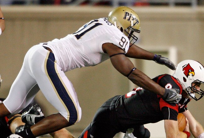 LOUISVILLE, KY - OCTOBER 02:  Adam Froman #9 of the Louisville Cardinals is sacked by Greg Romeus #91  of the Pittsburgh Panthers during the Big East Conference game at Papa John's Cardinal Stadium on October 2, 2009 in Louisville, Kentucky.  (Photo by Andy Lyons/Getty Images)