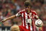 MUNICH, GERMANY - AUGUST 20:  Thomas Mueller of Bayern controls the ball during the Bundesliga match between FC Bayern Muenchen and VfL Wolfsburg at Allianz Arena on August 20, 2010 in Munich, Germany.  (Photo by Clive Brunskill/Getty Images)