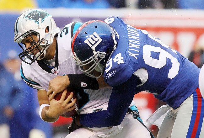 EAST RUTHERFORD, NJ - SEPTEMBER 12:  Matt Moore #3 of the Carolina Panthers is sacked in the fourth quarter by Mathias Kiwanuka #94 of the New York Giants on September 12, 2010 at the New Meadowlands Stadium in East Rutherford, New Jersey. The Giants defeated the Panthers 31-18.  (Photo by Jim McIsaac/Getty Images)