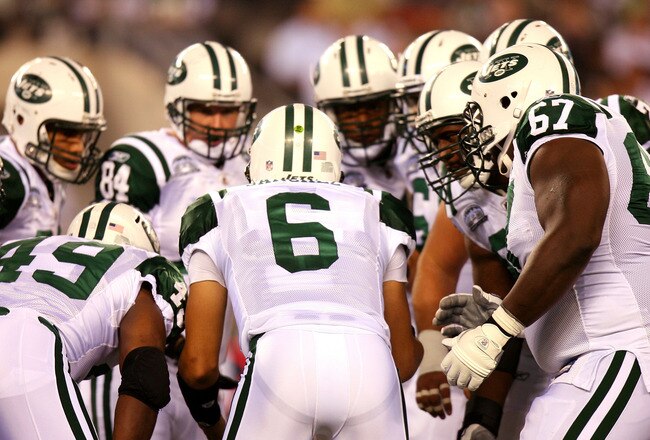 EAST RUTHERFORD, NJ - SEPTEMBER 13:  Mark Sanchez #6 of the New York Jets talks to his teammates in a huddle against the Baltimore Ravens during their home opener at the New Meadowlands Stadium on September 13, 2010 in East Rutherford, New Jersey.  (Photo by Andrew Burton/Getty Images)