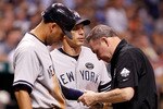 ST. PETERSBURG, FL - SEPTEMBER 15:  Shortstop Derek Jeter #2 (R) of the New York Yankees is examined by the team trainer, with manager Joe Girardi looking on, after he is allegedly hit by a pitch during the game against the Tampa Bay Rays at Tropicana Field on September 15, 2010 in St. Petersburg, Florida.  (Photo by J. Meric/Getty Images)