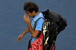 NEW YORK - SEPTEMBER 11:  Roger Federer of Switzerland leaves the court after losing to Novak Djokovic of Serbia during the men's singles semifinal match on day thirteen of the 2010 U.S. Open at the USTA Billie Jean King National Tennis Center on September 11, 2010 in the Flushing neighborhood of the Queens borough of New York City.  (Photo by Chris McGrath/Getty Images)