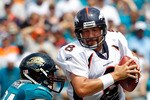 JACKSONVILLE, FL - SEPTEMBER 12:  Aaron Kampman #74 of the Jacksonville Jaguars attempts to tackle Quarterback Kyle Orton #8 of the Denver Broncos during the NFL season opener game at EverBank Field on September 12, 2010 in Jacksonville, Florida.  (Photo by Sam Greenwood/Getty Images)