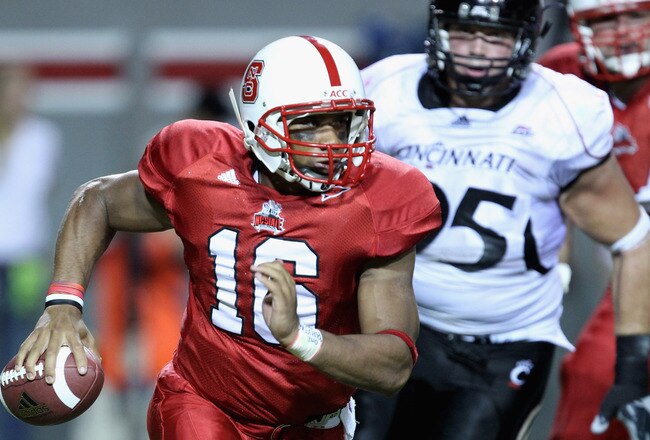 RALEIGH, NC - SEPTEMBER 16:  Derek Wolfe #95 of the Cincinnati Bearcats tries to chase down Russell Wilson #16 of the North Carolina State Wolfpack during their game at Carter-Finley Stadium on September 16, 2010 in Raleigh, North Carolina.  (Photo by Streeter Lecka/Getty Images)