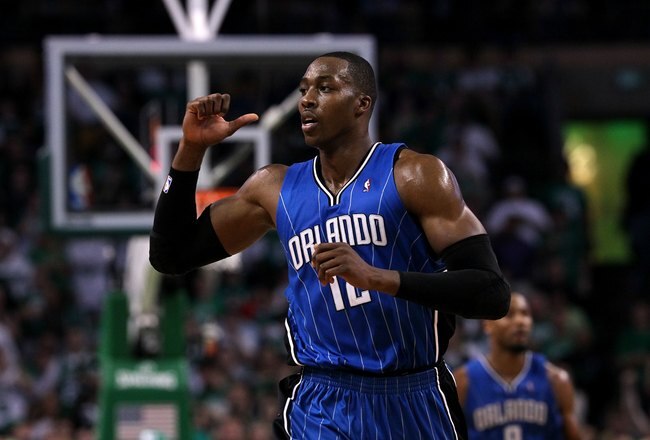 BOSTON - MAY 28:  Dwight Howard #12 of the Orlando Magic gestures as he runs up court against the Boston Celtics in Game Six of the Eastern Conference Finals during the 2010 NBA Playoffs at TD Garden on May 28, 2010 in Boston, Massachusetts.  NOTE TO USER: User expressly acknowledges and agrees that, by downloading and/or using this Photograph, user is consenting to the terms and conditions of the Getty Images License Agreement.  (Photo by Jim Rogash/Getty Images)