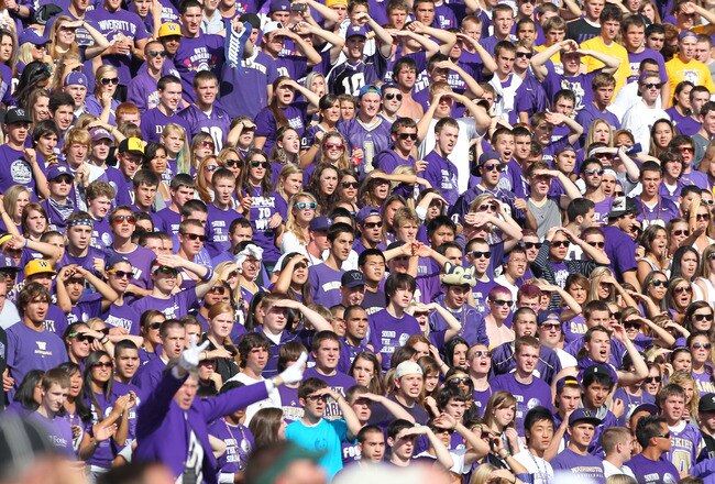 SEATTLE - SEPTEMBER 11:  Fans of the Washington Huskies watch their team take the field prior to the game against the Syracuse Orange on September 11, 2010 at Husky Stadium in Seattle, Washington. (Photo by Otto Greule Jr/Getty Images)
