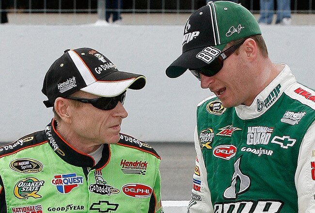 LOUDON, NH - SEPTEMBER 17:  (L-R) Mark Martin, driver of the #5 GoDaddy.com Chevrolet, talks with teammate Dale Earnhardt Jr., driver of the #88 AMP Energy/National Guard Chevrolet, during qualifying for the NASCAR Sprint Cup Series Sylvania 300 at New Hampshire Motor Speedway on September 17, 2010 in Loudon, New Hampshire.  (Photo by Tom Whitmore/Getty Images for NASCAR)