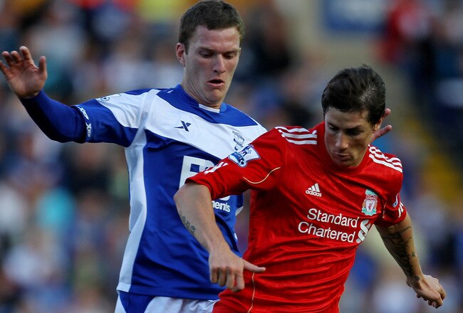 BIRMINGHAM, ENGLAND - SEPTEMBER 12:  Fernando Torres of Liverpool tussles for posession with Craig Gardner of Birmingham City during the Barclays Premier League match between Birmingham City and Liverpool at St Andrew's Stadium on September 12, 2010 in Birmingham, England.  (Photo by Alex Livesey/Getty Images)