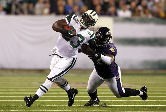 EAST RUTHERFORD, NJ - SEPTEMBER 13:  Shonn Greene #23 of the New York Jets gets tackeled by Jameel McClain #53 of the Baltimore Ravens during their home opener at the New Meadowlands Stadium on September 13, 2010 in East Rutherford, New Jersey.  (Photo by Jim McIsaac/Getty Images)