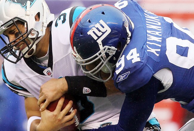 EAST RUTHERFORD, NJ - SEPTEMBER 12:  Matt Moore #3 of the Carolina Panthers is sacked in the fourth quarter by Mathias Kiwanuka #94 of the New York Giants on September 12, 2010 at the New Meadowlands Stadium in East Rutherford, New Jersey. The Giants defeated the Panthers 31-18.  (Photo by Jim McIsaac/Getty Images)