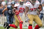SEATTLE - SEPTEMBER 12:  Running back Frank Gore #21 of the San Francisco 49ers rushes as Mike Iupati #77 blocks for him during the NFL season opener against the Seattle Seahawks at Qwest Field on September 12, 2010 in Seattle, Washington. (Photo by Otto Greule Jr/Getty Images)